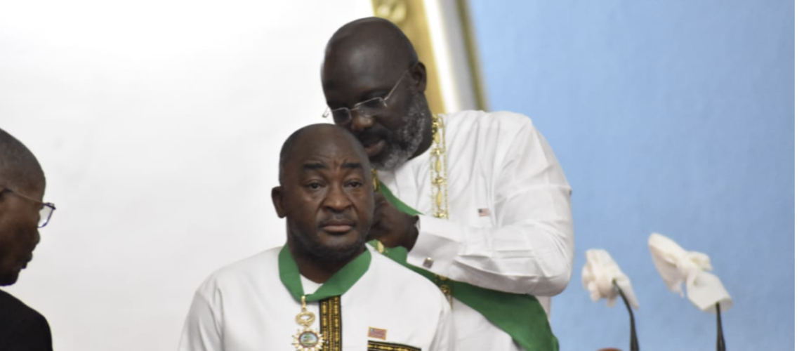 H. E. President Weah decorating Foreign Minister Kemayah at Liberia’s 176th Independence Anniversary Celebration